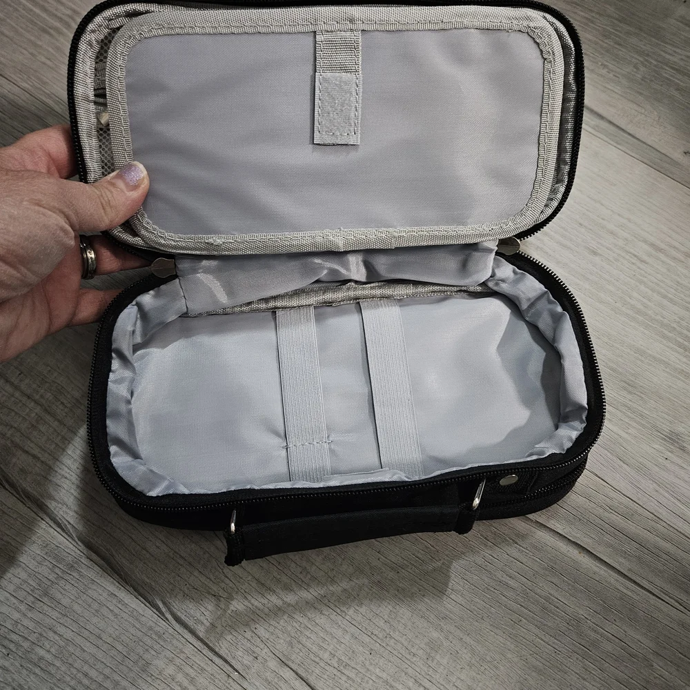 Torfly pencil case. Black with 2 zipper pouches and handle. Torly logo on front.